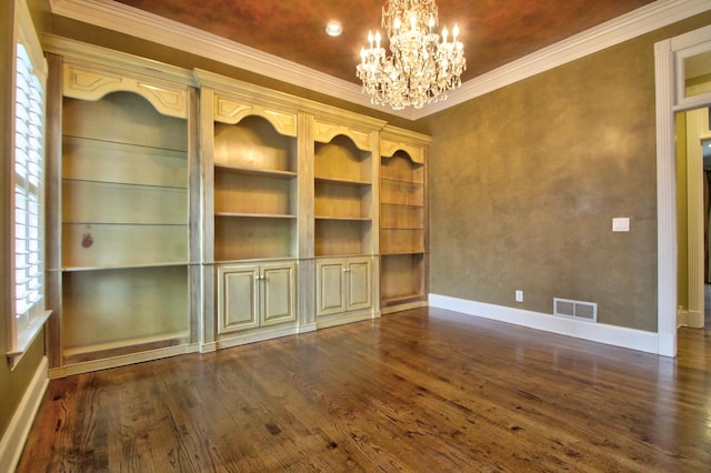 unfurnished room featuring a chandelier, ornamental molding, dark hardwood / wood-style flooring, and a healthy amount of sunlight