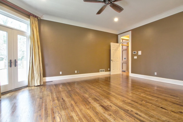 empty room featuring ornamental molding, hardwood / wood-style floors, ceiling fan, and french doors