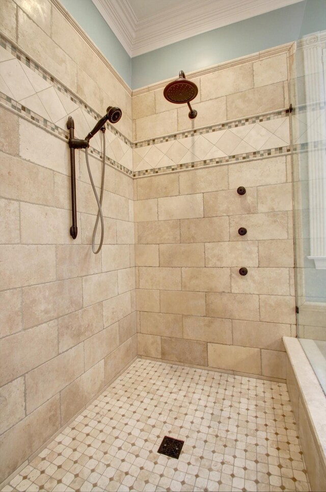 bathroom featuring ornamental molding and tiled shower