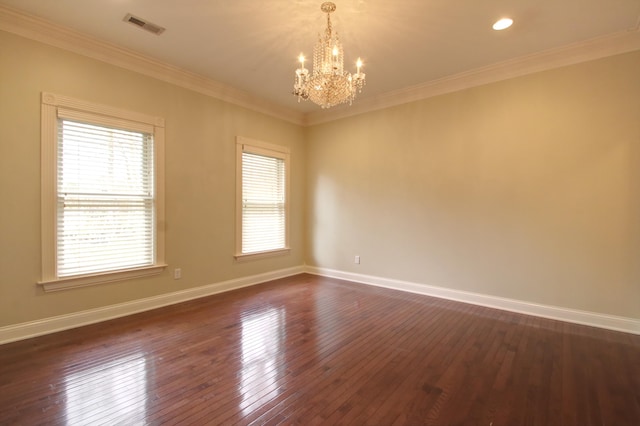 empty room with an inviting chandelier, dark wood-type flooring, and ornamental molding