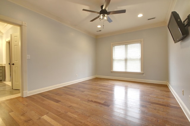 spare room with ceiling fan, wood-type flooring, and crown molding