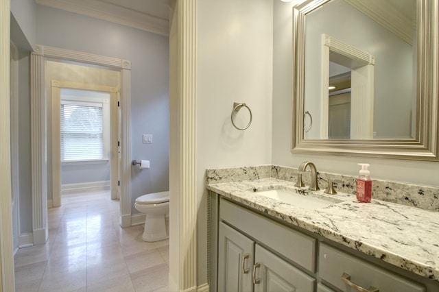 bathroom with crown molding, vanity, toilet, and tile patterned flooring