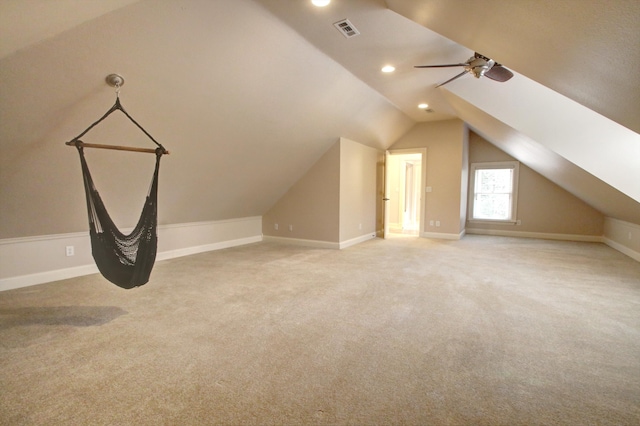 additional living space featuring ceiling fan, light colored carpet, and vaulted ceiling