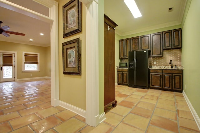 corridor with ornamental molding, sink, and light tile patterned floors