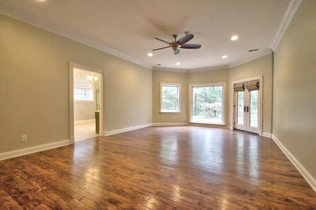 empty room featuring ceiling fan with notable chandelier, crown molding, and dark wood-type flooring