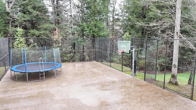 view of patio / terrace featuring basketball court and a trampoline