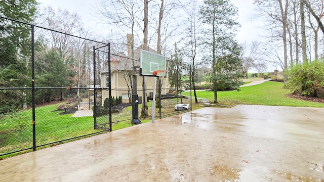 view of basketball court with a yard