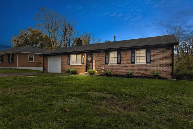 ranch-style house featuring a garage and a front lawn