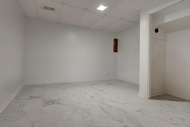 unfurnished room with a drop ceiling