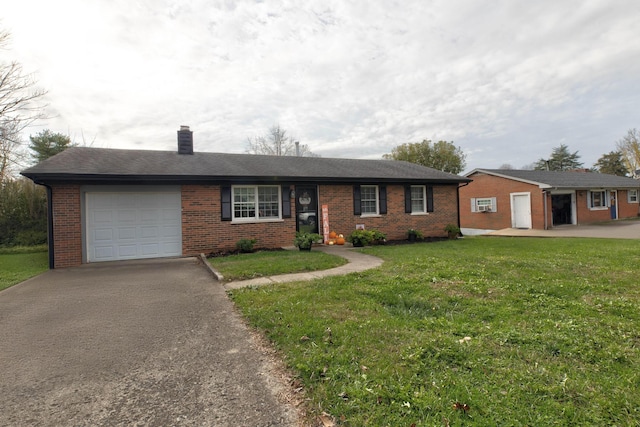 single story home featuring a garage and a front lawn