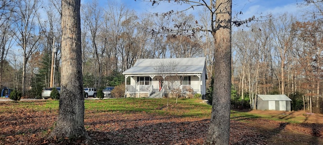 view of front facade featuring a porch and a shed