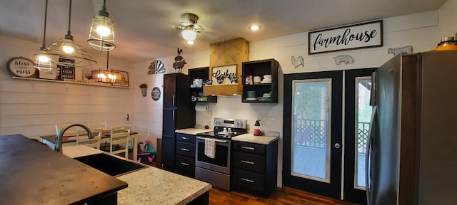 kitchen with appliances with stainless steel finishes, ceiling fan, sink, decorative light fixtures, and dark hardwood / wood-style floors