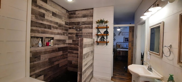 bathroom with a shower, vanity, wood-type flooring, and ceiling fan