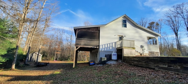 back of house with central AC unit