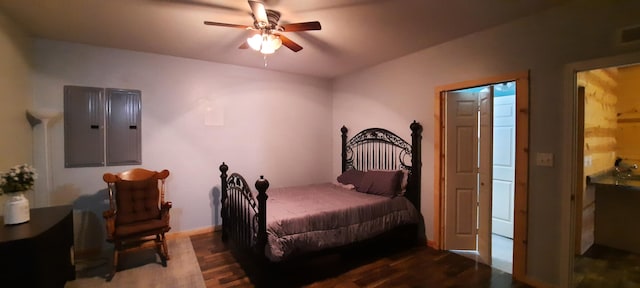 bedroom with wood-type flooring, electric panel, and ceiling fan