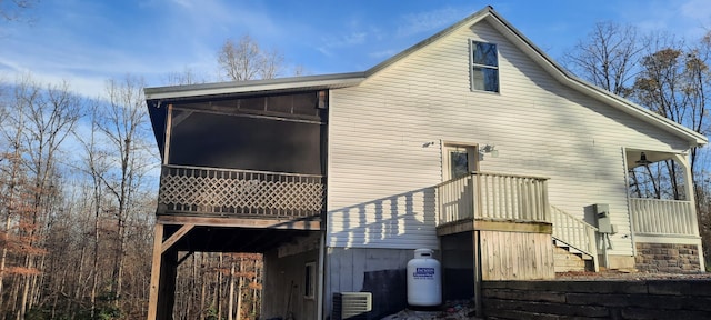 back of property with a sunroom