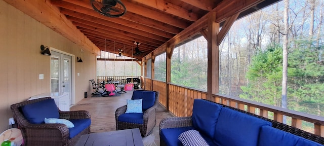 sunroom featuring a wealth of natural light, wooden ceiling, and vaulted ceiling