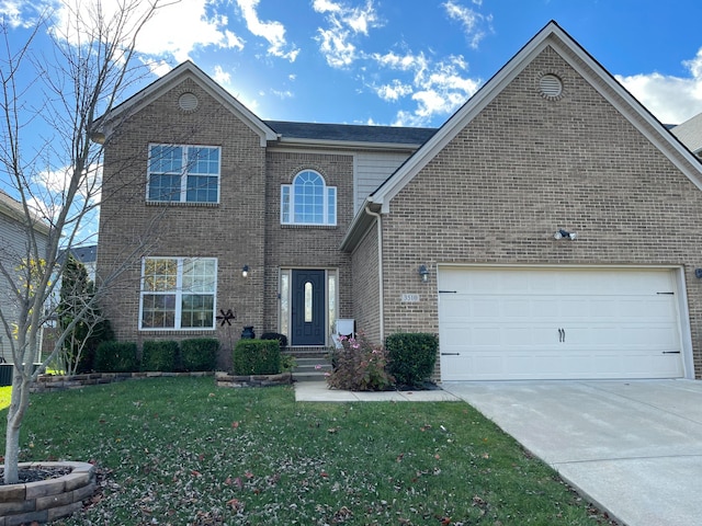 front of property with a front yard and a garage