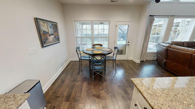 dining area with dark wood-type flooring