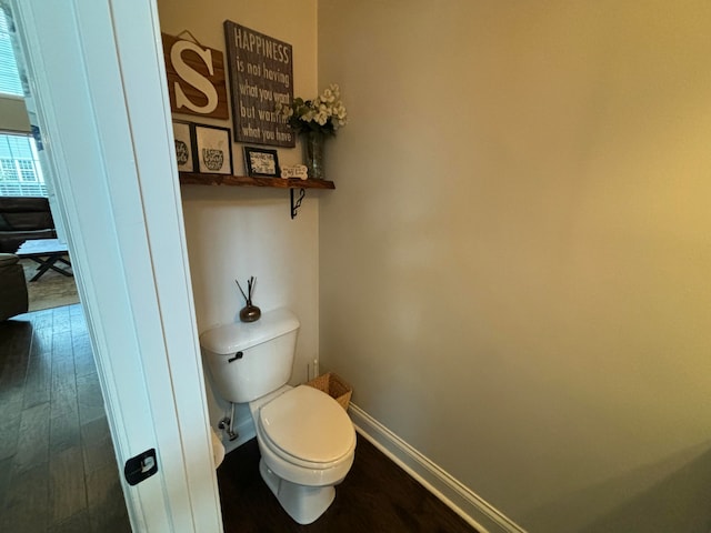 bathroom with hardwood / wood-style floors and toilet