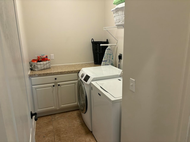 washroom featuring cabinets and independent washer and dryer