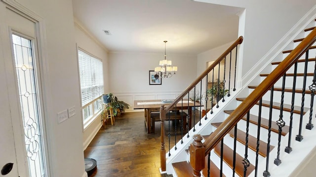 dining area featuring a chandelier, dark hardwood / wood-style floors, and ornamental molding