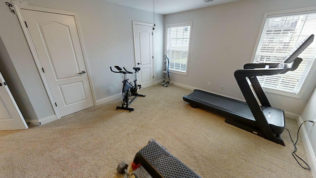 exercise area featuring light colored carpet and a wealth of natural light