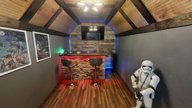 interior space featuring lofted ceiling with beams, wooden ceiling, ceiling fan, and dark wood-type flooring