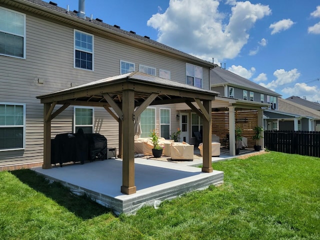 back of house with a lawn, a patio, and a gazebo