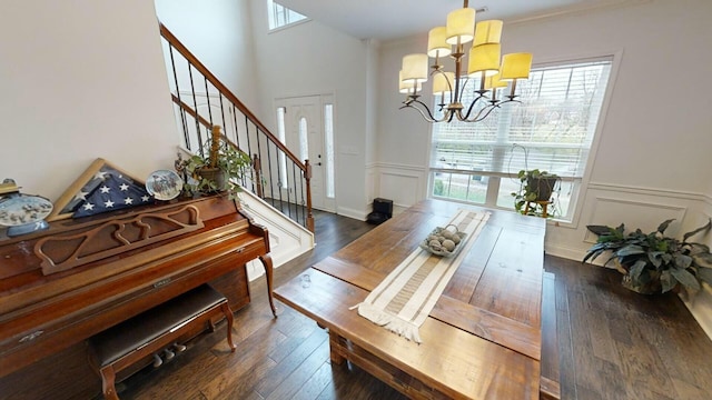 dining area featuring a notable chandelier, plenty of natural light, and dark wood-type flooring