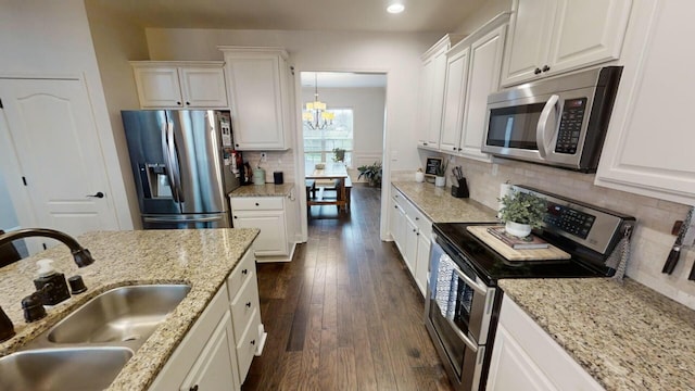 kitchen with dark wood-type flooring, sink, white cabinets, and stainless steel appliances