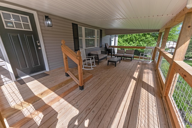 wooden deck featuring an outdoor living space and covered porch