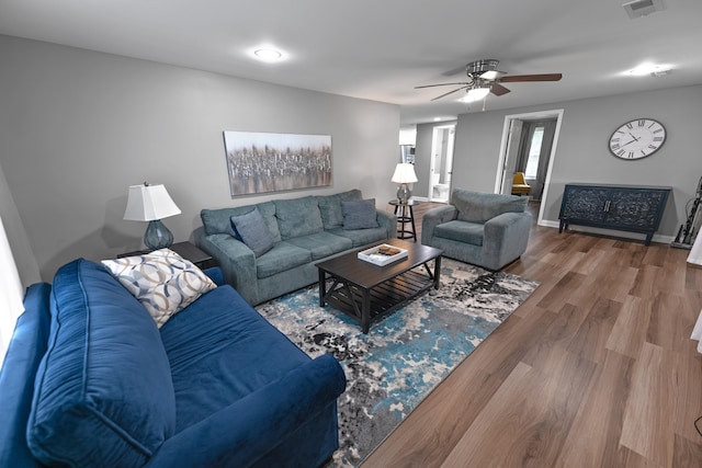 living room featuring hardwood / wood-style flooring and ceiling fan