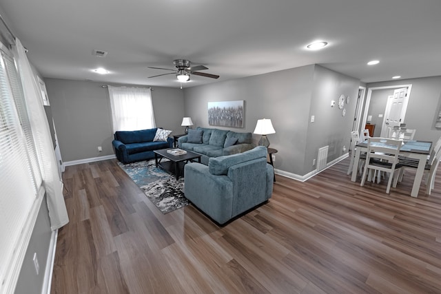 living room with ceiling fan and wood-type flooring