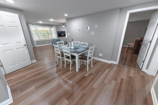 dining room with ceiling fan and light wood-type flooring