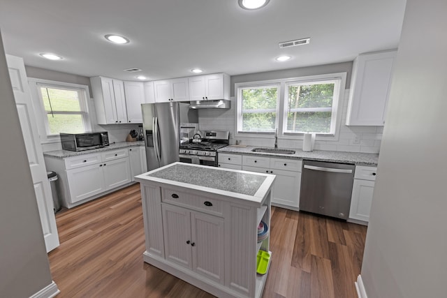 kitchen featuring a kitchen island, white cabinetry, and stainless steel appliances