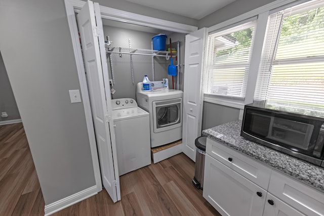 washroom with dark hardwood / wood-style flooring and washer and dryer