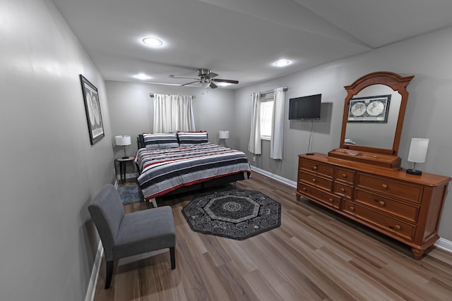 bedroom featuring ceiling fan and dark hardwood / wood-style flooring