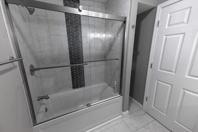 bathroom with shower / bath combination with glass door