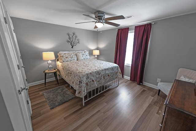 bedroom with ceiling fan and hardwood / wood-style floors