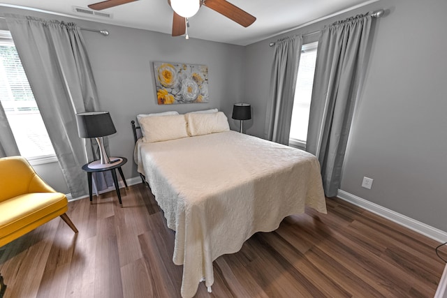 bedroom with ceiling fan and dark hardwood / wood-style flooring