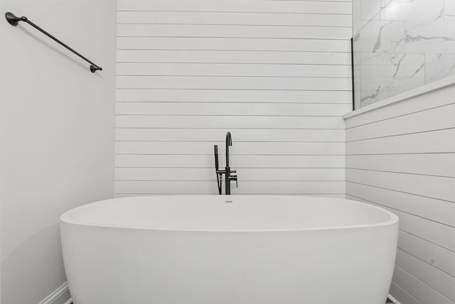 full bath with a freestanding bath