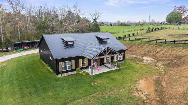 birds eye view of property with a rural view