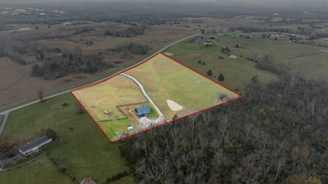 birds eye view of property with a rural view