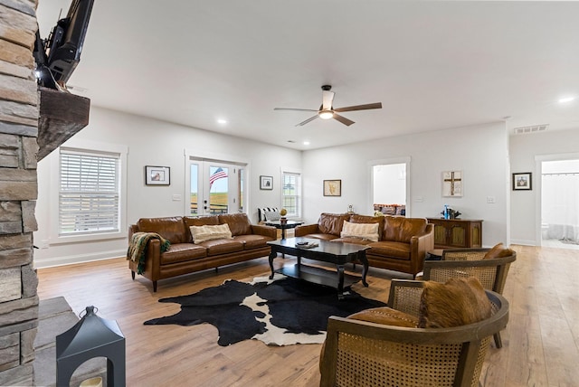 living area with baseboards, visible vents, a ceiling fan, light wood-style floors, and recessed lighting