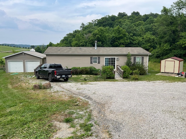 view of front of home featuring a garage and a storage unit