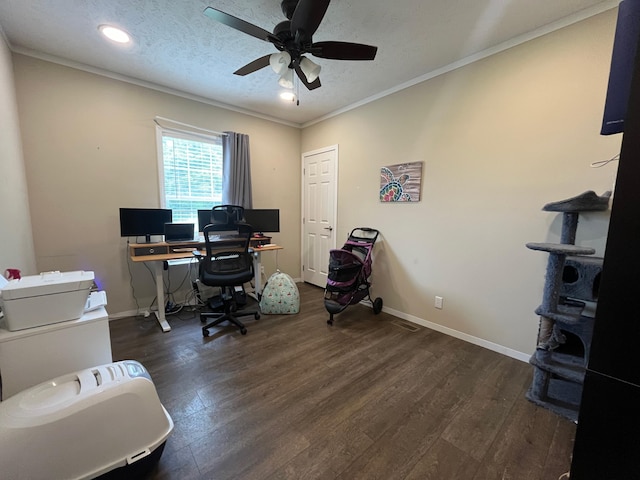 office space with crown molding, ceiling fan, dark wood-type flooring, and a textured ceiling