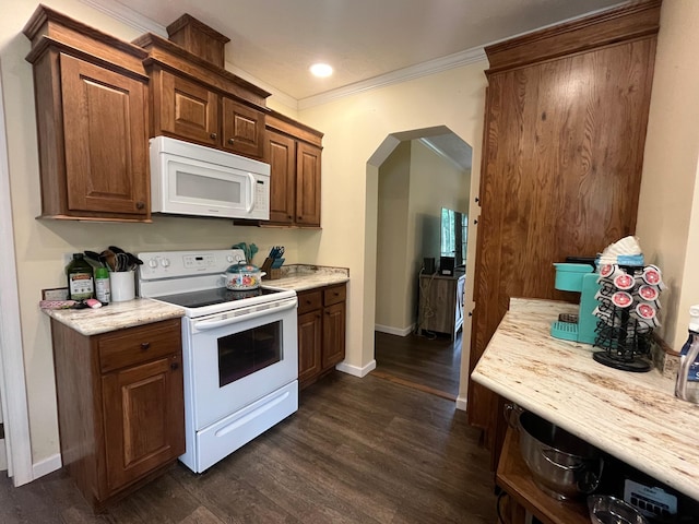 kitchen featuring crown molding, dark hardwood / wood-style flooring, and white appliances