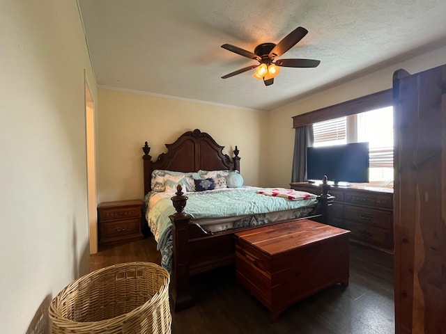 bedroom with ceiling fan, dark hardwood / wood-style flooring, a textured ceiling, and ornamental molding