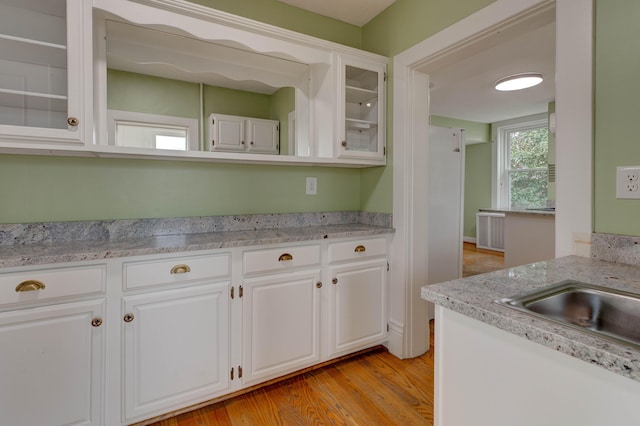 kitchen featuring white cabinets and light wood-type flooring